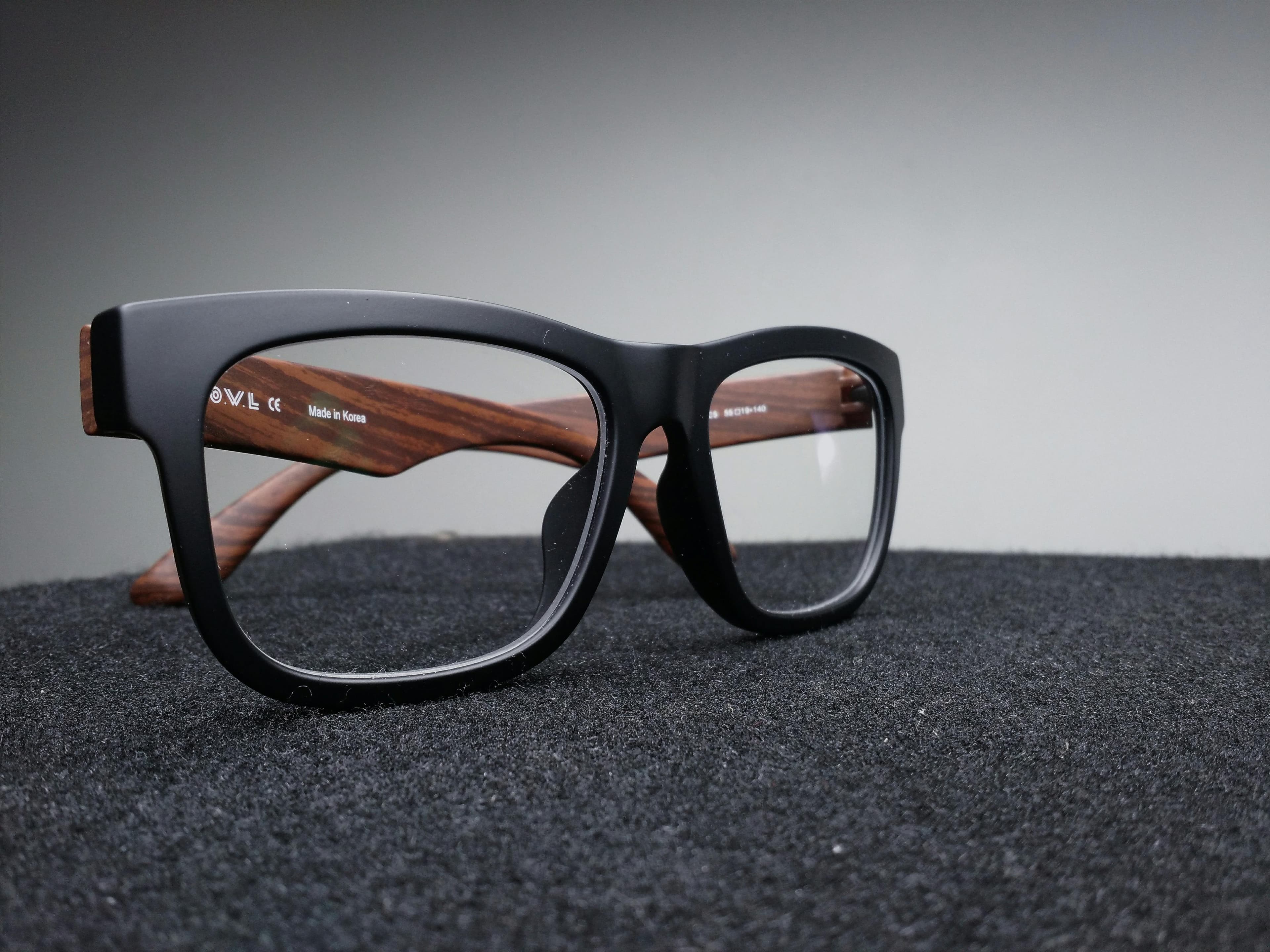 A person wearing modern eyeglasses in a city