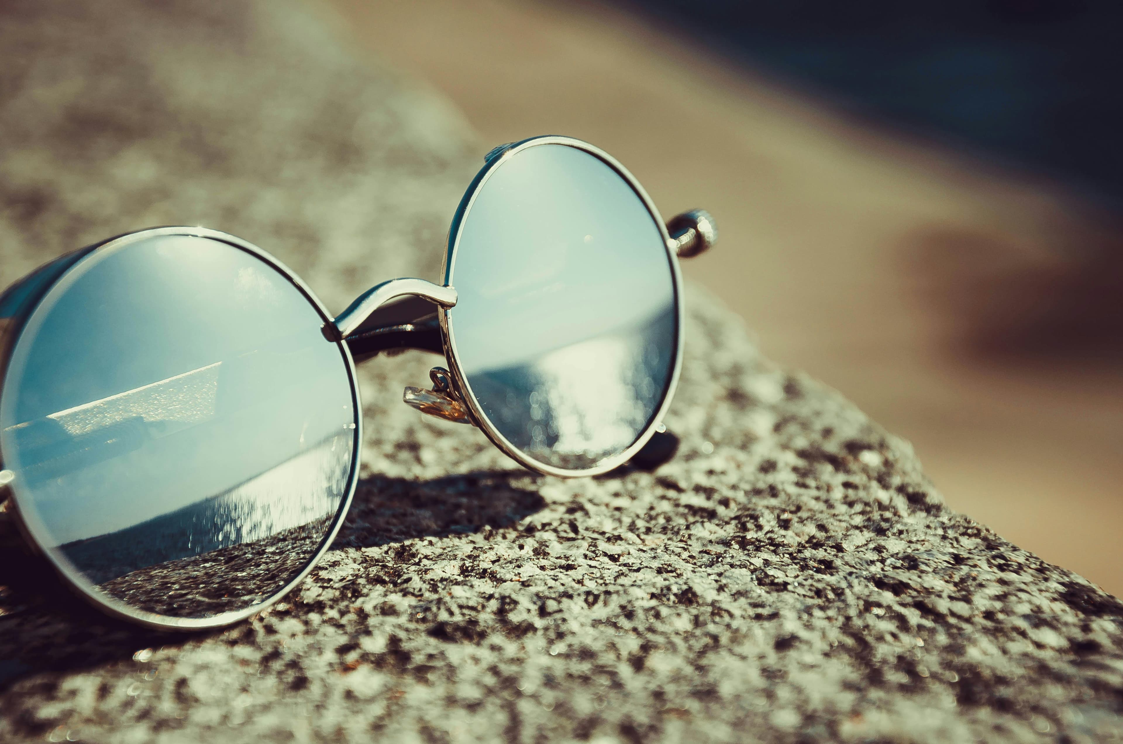 Stylish sunglasses on a beach background